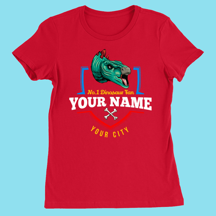 Show off your love for dinos with the N.1 Stegosaurus Fan Custom Women T-Shirt by Jurassic Studio! Features a red tee, teal dinosaur head, crossed bones, custom YOUR NAME and CITY text, and No.1 Dinosaur Fan on a light blue background.