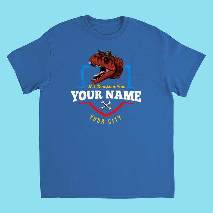 The Jurassic Studio N.1 Carnotaurus Fan Custom Kids T-Shirt features a red Carnotaurus head, N.1 Dinosaur fan YOUR NAME YOUR CITY in white and yellow, crossed pickaxes, on a light blue background—a perfect personalized dinosaur gift!.