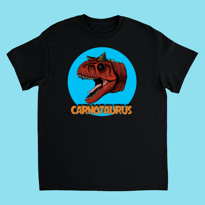 The Kids Carnotaurus Head T-Shirt by Jurassic Studio features a bold red Carnotaurus dinosaur head in a blue circle with orange lettering—an exclusive gift for young dinosaur fans.