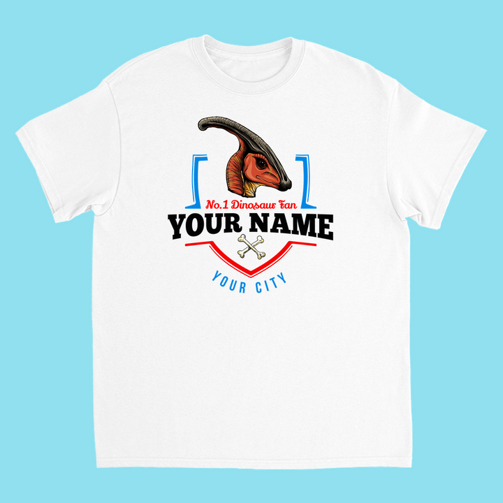 The N.1 Hadrosaur Fan Custom Kids T-shirt by Jurassic Studio features a colorful Parasaurolophus, bold No. 1 Dinosaur Fan text, your child’s name and city, crossed bones—all on light blue. A perfect personalized dinosaur gift!.