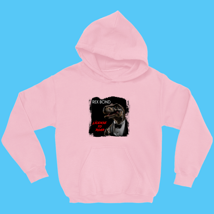 The Jurassic Studio Kids Rex Bond Hoodie is a playful pink hoodie featuring a dinosaur in a suit with REX BOND and LICENSE TO ROAR text—a fun James Bond parody perfect for young dinosaur fans.