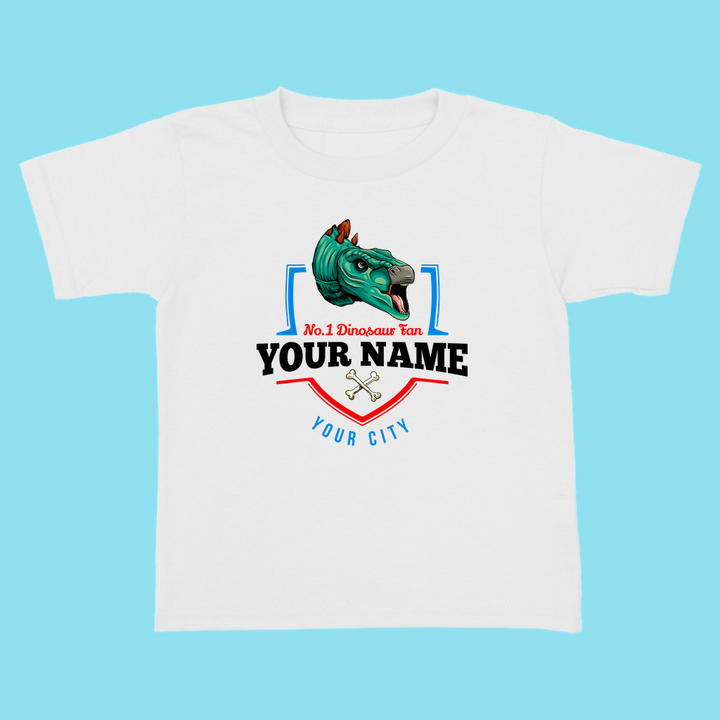 The N.1 Stegosaurus Fan Custom Toddler T-Shirt by Jurassic Studio features a green dinosaur head, crossed bones, and areas for your childs name and city—ideal as a personalized dinosaur shirt or unique toddler gift.