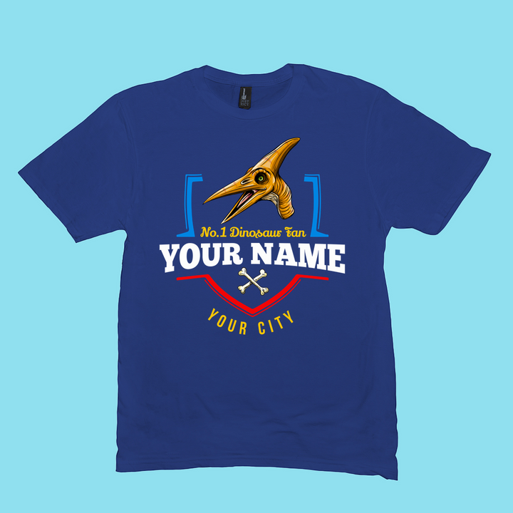 The Jurassic Studio N.1 Pterodactyl Fan Custom Men T-Shirt features a blue cartoon pterodactyl head, No. 1 Dinosaur Fan, your bold white name, yellow city name, and crossed bones—a unique personalized tee!.