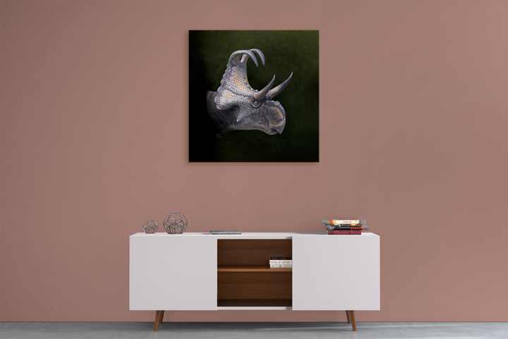 A minimalist room with a mauve wall, a white sideboard holding decor and books, and the Triceratops Portrait Canvas Wrap by Jurassic Studio hanging above the sideboard.