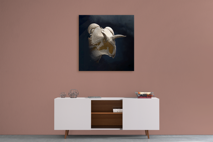A minimalist room with a mauve wall features a white sideboard, geometric decor, books, and the Jurassic Studio Medusaceratops Portrait Canvas Wrap displayed as dinosaur art above.