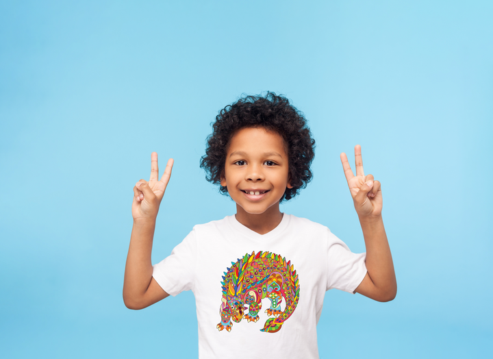 Smiling child with curly hair in a Kids Ankylosaurus Zentangle T-Shirt by Jurassic Studio, striking peace signs on a plain blue background—a colorful exclusive, perfect as a dinosaur gift for fans.