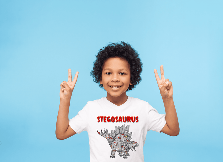 A curly-haired child in a Kids Robot Stegosaurus T-Shirt from Jurassic Studio makes peace signs against a light blue backdrop—the perfect gift for young dinosaur fans.