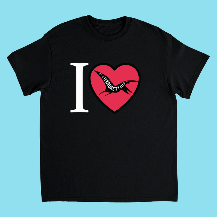 The Kids I Love Pterodactyl T-Shirt by Jurassic Studio features a heart-shaped pterodactyl silhouette and I ♥ PTERODACTYLUS text—ideal for any young dinosaur fan. The light blue background adds a fun, playful touch.