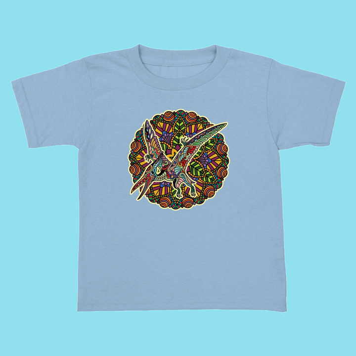 The Jurassic Studio Toddler Pterodactyl Mandala T-Shirt showcases a vibrant, patterned pterodactyl design on light blue—an exclusive gift for young dinosaur fans.
