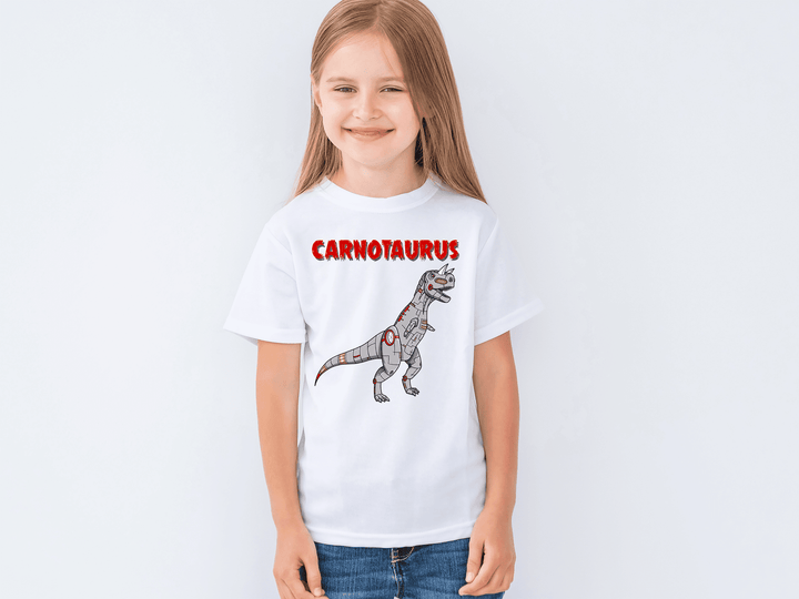 Smiling young girl in a Jurassic Studio Kids Robot Carnotaurus T-Shirt, featuring a cartoon gray Carnotaurus and bold red CARNOTAURUS text—ideal gift for dino fans.