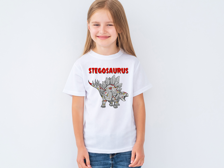 A smiling girl with long blonde hair wears the white Kids Robot Stegosaurus T-Shirt by Jurassic Studio, featuring a cartoon stegosaurus and bold red STEGOSAURUS text—a great dinosaur gift for fans.