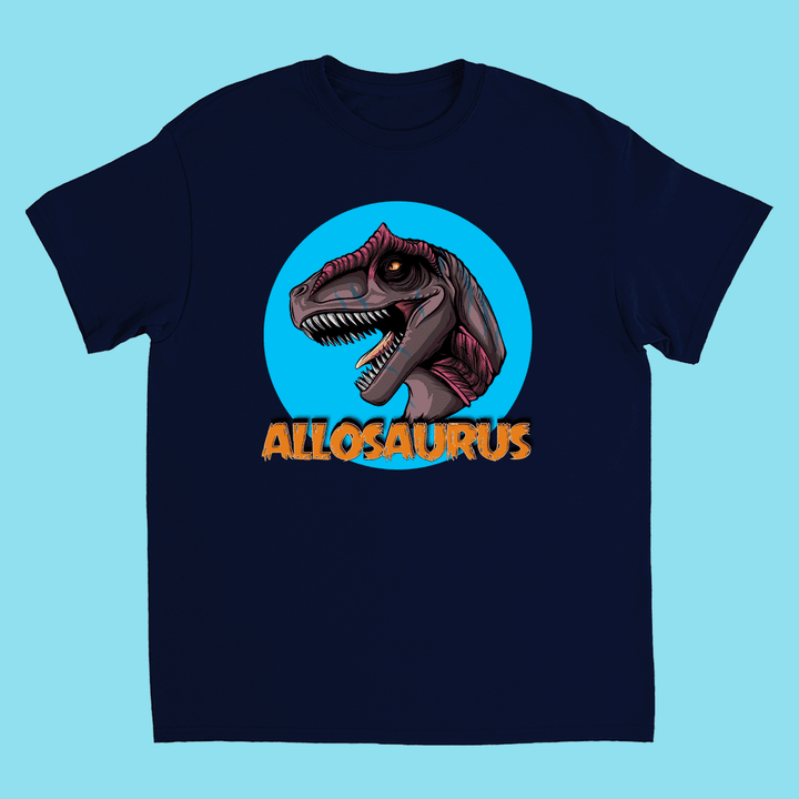 The Kids Allosaurus Head T-Shirt by Jurassic Studio features a fierce Allosaurus head in a blue circle and bold orange “ALLOSAURUS” text—an exclusive, perfect gift for young dinosaur fans.