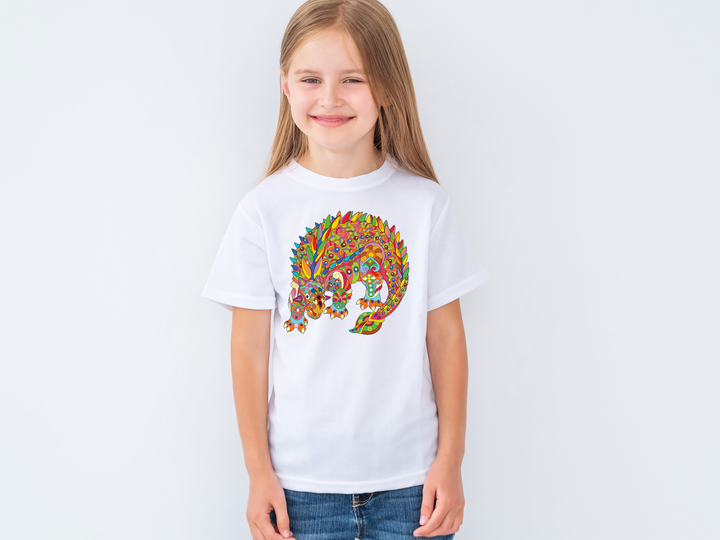 A smiling young girl wears the Jurassic Studio Kids Ankylosaurus Zentangle T-Shirt with a vibrant chameleon-like dino design, set against a plain white background—an ideal gift for dinosaur fans.