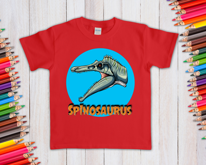 The Kids Spinosaurus Head T-Shirt by Jurassic Studio features a cartoon Spinosaurus head in a blue circle with bold SPINOSAURUS text—a playful design perfect for young dinosaur fans.