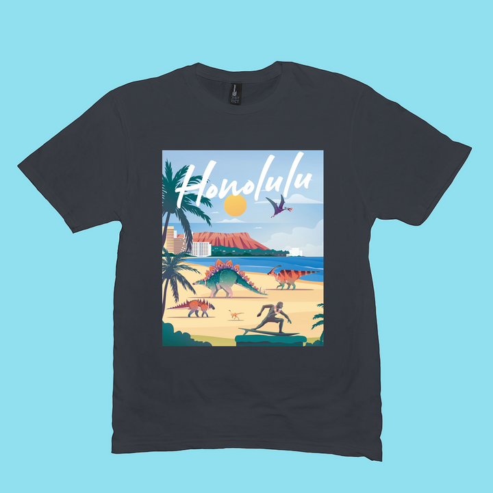 The Jurassic Studio Men Honolulu T-Shirt is a 100% cotton black shirt with colorful dinosaurs on a tropical beach, palm trees, ocean, and mountains. “Honolulu” in bold white script tops the design—an ideal gift for any dinosaur fan.
