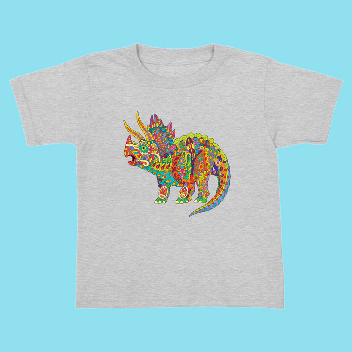 The Toddler Triceratops Zentangle T-Shirt by Jurassic Studio features a colorful folk art dinosaur design with bright patterns, making it a perfect gift for young fans. This exclusive tee displays vibrant colors on a light blue background.