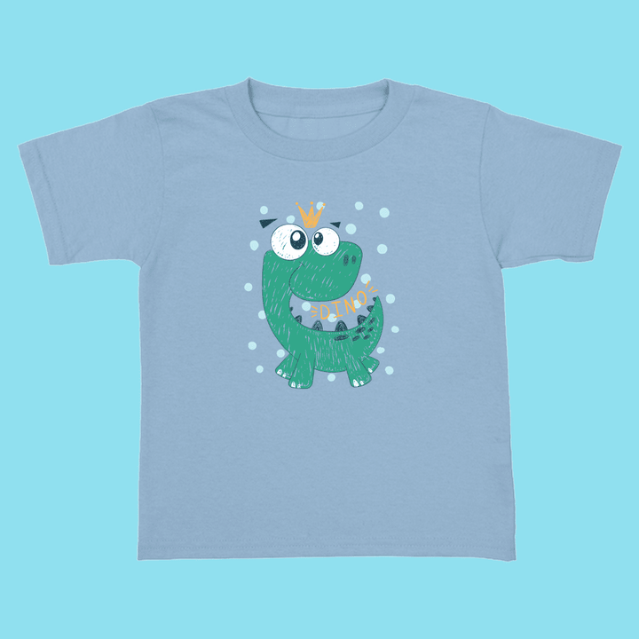 Jurassic Studio’s Toddler Baby Green Dino T-Shirt is 100% cotton, light blue, and features a smiling green dinosaur with a yellow crown, white dots, and “DINO” on its body—perfect for little dinosaur fans.