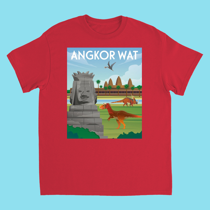 Jurassic Studio’s Kids Angkor Wat T-Shirt features colorful dinosaurs, palm trees, a flying pterosaur, and stone faces at Angkor Wat beneath ANGKOR WAT in the sky—a vibrant design for dino-loving kids.