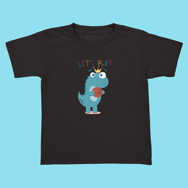The Toddler Baby Dino Basketball T-Shirt by Jurassic Studio features a cute blue cartoon dino with sneakers, a crown, and basketball under LETS PLAY text. A Jurassic Studio exclusive—perfect for little dinosaur fans!.