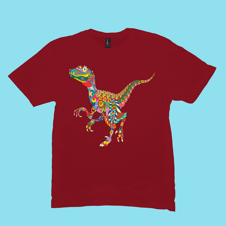 The Men Velociraptor Zentangle T-Shirt by Jurassic Studio features a colorful patterned dinosaur on a red tee with a light blue backdrop, blending fun and vibrant Jurassic style.