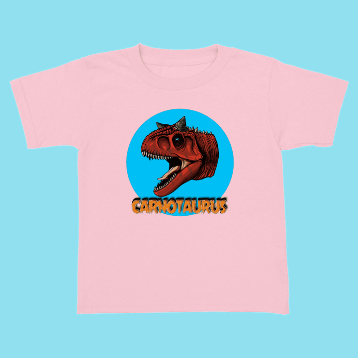 The Jurassic Studio Toddler Carnotaurus Head T-Shirt features a roaring dino head in a blue circle with bold orange CARNOTAURUS—the perfect gift for any little dinosaur fan!.