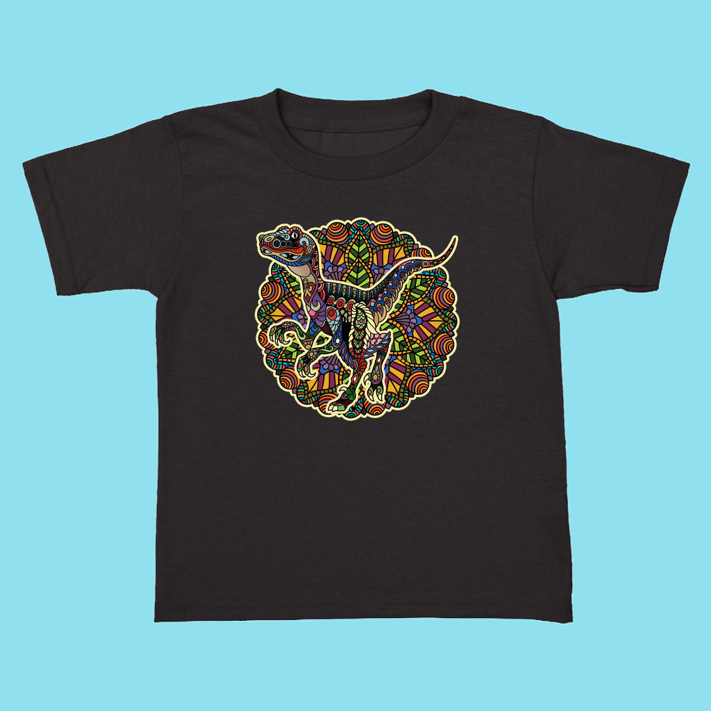 The Toddler Velociraptor Mandala T-Shirt by Jurassic Studio is a black tee with a vibrant mandala-style raptor graphic—perfect for young dinosaur fans and available exclusively from Jurassic Studio.