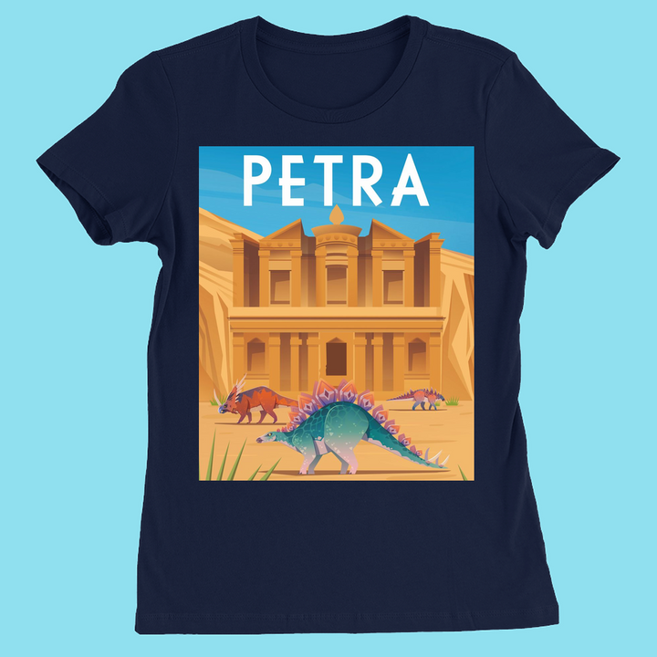 The Women Petra T-Shirt by Jurassic Studio is a navy blue slim fit tee with Petra’s ancient facade, three dinosaurs—including a colorful stegosaurus—and “PETRA” at the top. Exclusive design.
