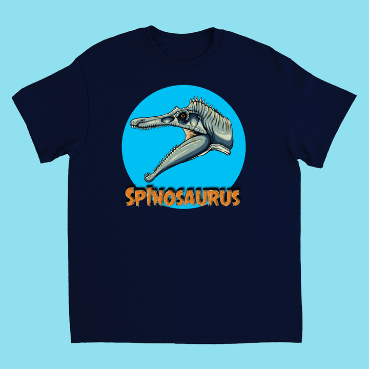 The Kids Spinosaurus Head T-Shirt by Jurassic Studio features a navy blue design with a Spinosaurus head inside a blue circle and “SPINOSAURUS” in bold orange letters below.