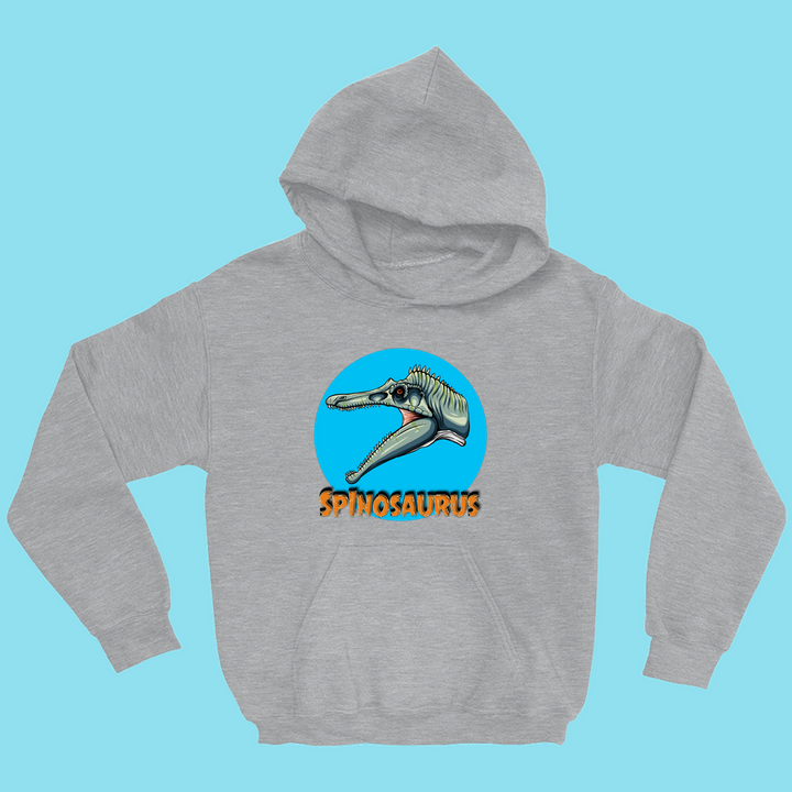 The Kids Spinosaurus Head Hoodie by Jurassic Studio features a colorful spinosaurus head in a blue circle above orange SPINOSAURUS text, shown on a solid light blue background.