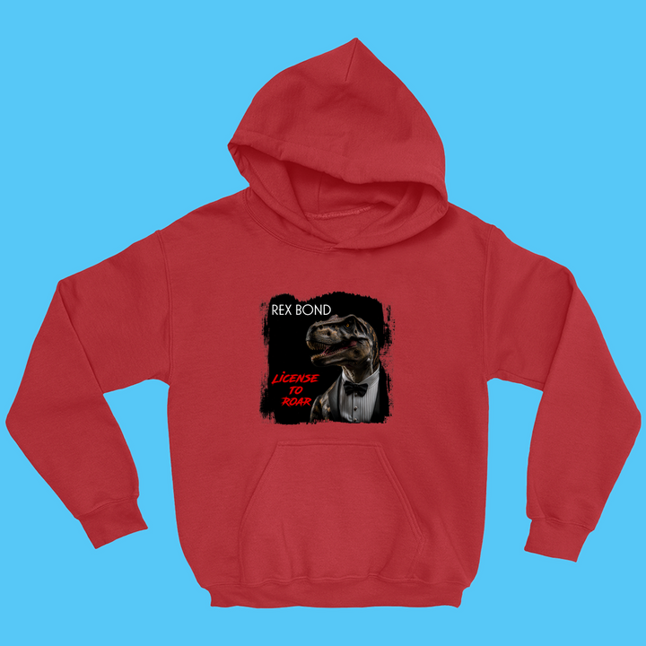 The Kids Rex Bond Hoodie by Jurassic Studio features a T. rex in a tuxedo with Rex Bond and License to Roar text on a light blue background—a playful James Bond parody, perfect for dinosaur fans.