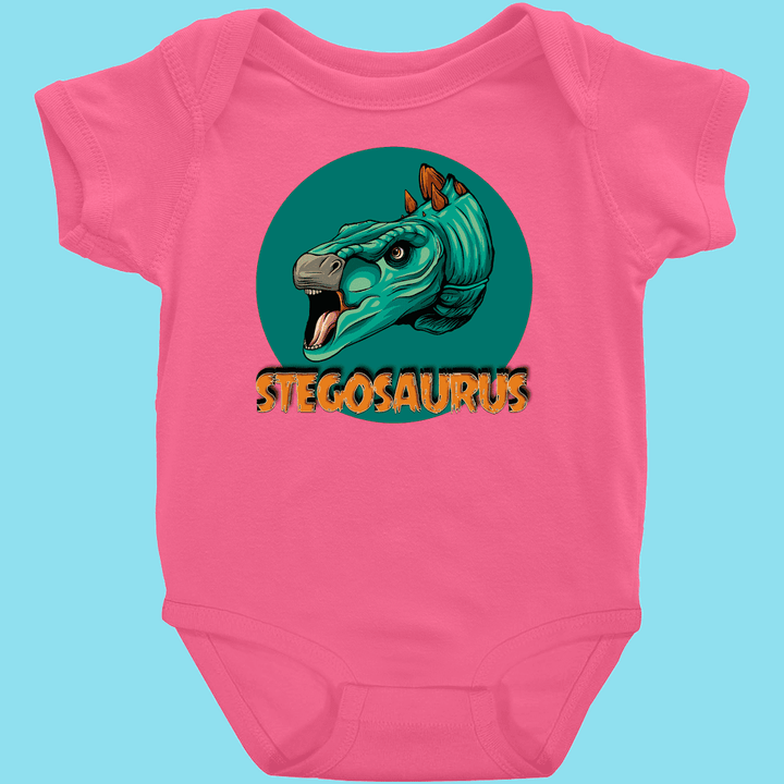 The Toddler Stegosaurus Head Onesie by Jurassic Studio features a cute green stegosaurus head in a teal circle above bold orange STEGOSAURUS text—an adorable outfit for little dinosaur fans.
