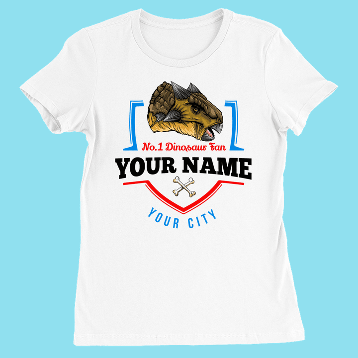 The Jurassic Studio N.1 Ankylosaurus Fan Custom Women T-Shirt features an illustrated dinosaur head, No.1 Dinosaur Fan, your name, your city, a small pair of bones below, and a light blue background for a personalized touch.