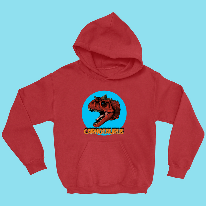 Exclusive to Jurassic Studio, the Kids Carnotaurus Head Hoodie features a roaring Carnotaurus graphic in a blue circle with bold yellow lettering on a light blue background—perfect for any dino fan!.