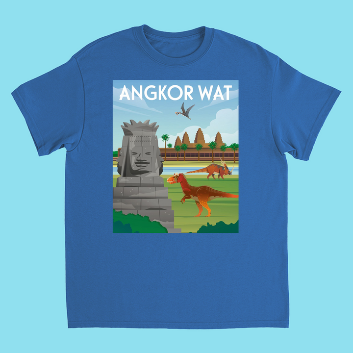 The Kids Angkor Wat T-Shirt by Jurassic Studio features dinosaurs, a large stone face, palm trees, and a flying pterosaur with ANGKOR WAT text—perfect for young explorers who love dinosaurs!.