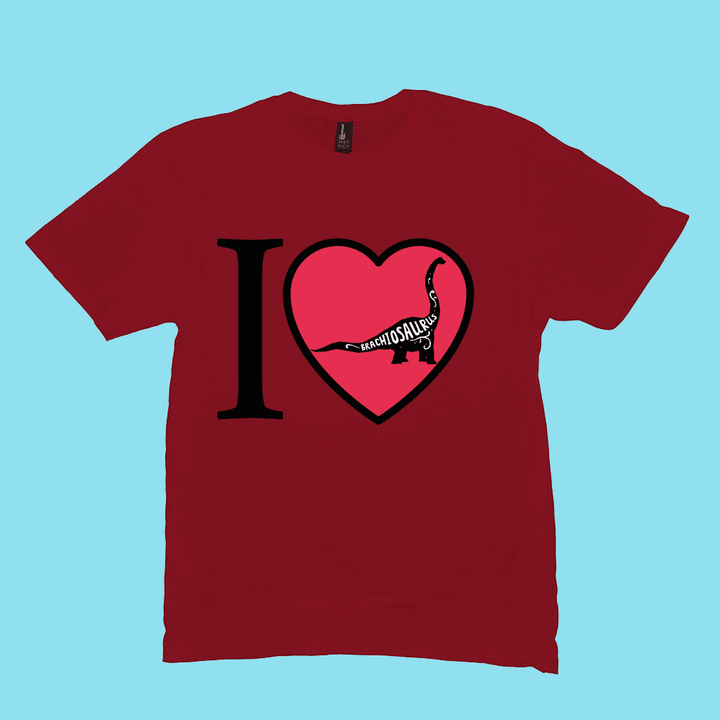 The Men I Love Brachiosaurus T-Shirt by Jurassic Studio features a large black I, red heart with a white Brachiosaurus outline and BRACHIOSAURS, set on light blue. A perfect gift for dinosaur fans, exclusive from Jurassic Studio.