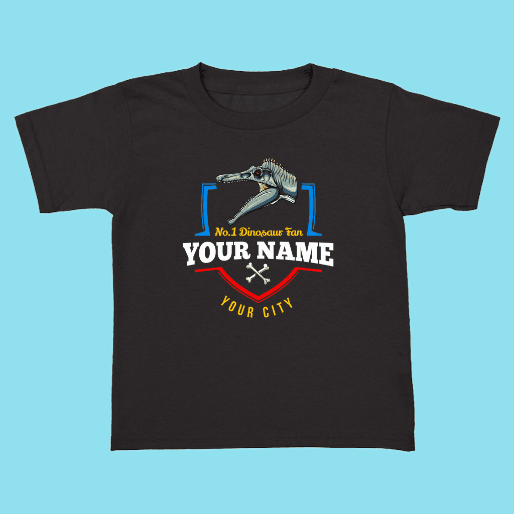 Jurassic Studio’s N.1 Spinosaurus Fan Custom Toddler T-Shirt features a dinosaur skull graphic and “No. 1 Dinosaur Fan” text on black, with customizable name and city—an ideal personalized dinosaur gift for toddlers!.