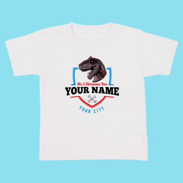 The N.1 Allosaurus Fan Custom Toddler T-Shirt by Jurassic Studio features a cartoon allosaurus above No. 1 Dinosaur Fan, customizable with your childs name and city—a fun, personalized dinosaur shirt for toddlers on a blue background.