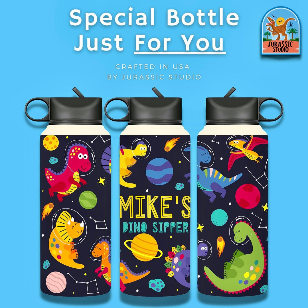 Three colorful stainless steel bottles with black lids showcase playful dinosaur and space designs. The center bottle says MIKES DINO SIPPER. Above, text highlights the Customized Dino Sipper Stainless Steel Bottle by Jurassic Studio.