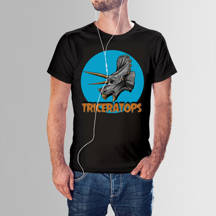 A man wears the Men Triceratops Head T-Shirt by Jurassic Studio, featuring a bold dinosaur graphic and “TRICERATOPS” text—perfect for any dinosaur fan. He stands casually with one hand in his pocket, earphones on.