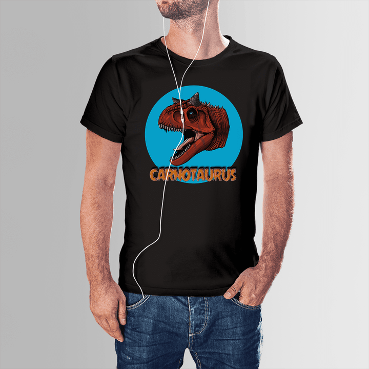 A man, with one hand in his pocket and earphones on, wears the Men Carnotaurus Head T-Shirt by Jurassic Studio featuring a Carnotaurus graphic inside a blue circle with CARNOTAURUS beneath—an exclusive gift for dinosaur fans.