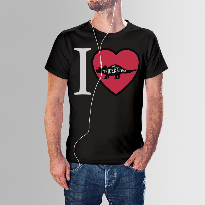 Wearing the Men I Love Triceratops T-Shirt by Jurassic Studio, a man with earphones and hand in his pocket displays this black tee featuring an I ♥ Triceratops design—a perfect gift for dinosaur lovers.