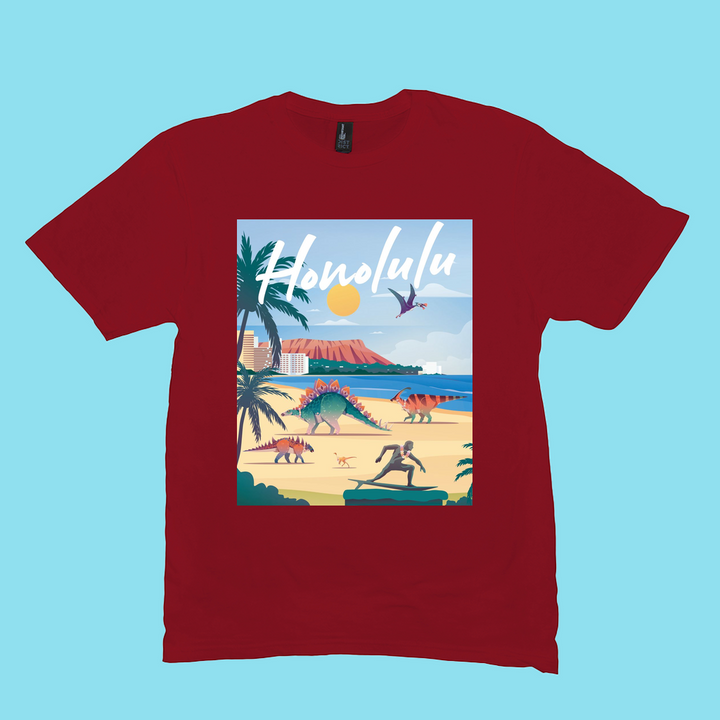 The Men Honolulu T-Shirt by Jurassic Studio features a red design with dinosaurs, palm trees, a surfer, and Honolulu in cursive above a sunlit mountain and ocean. Made from 100% cotton, its the perfect gift for dinosaur fans.