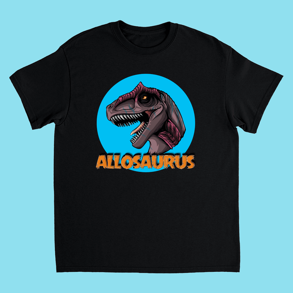 The Kids Allosaurus Head T-Shirt by Jurassic Studio features a cartoon Allosaurus head in a blue circle, ALLOSAURUS in bold orange below, and a light blue background—perfect for dinosaur fans.