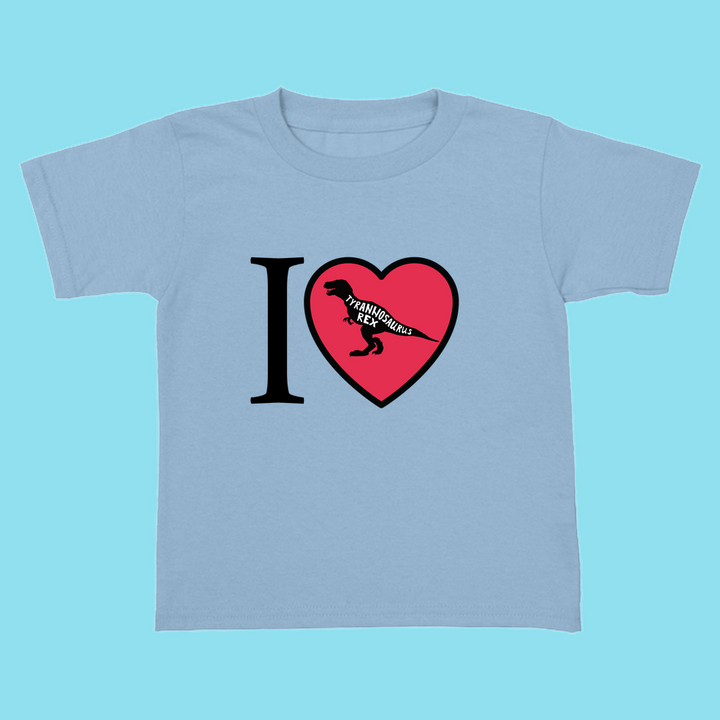 The Jurassic Studio Toddler I Love T-Rex T-Shirt features a light blue background and I ♥ with a black T-Rex silhouette and TYRANNOSAURUS in the heart—perfect dinosaur shirt for little fans.