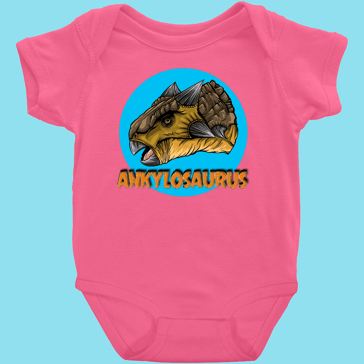 The Toddler Ankylosaurus Head Onesie by Jurassic Studio features a cartoon Ankylosaurus head in a blue circle with ANKYLOSAURUS in bold yellow letters—a Jurassic Studio exclusive!.