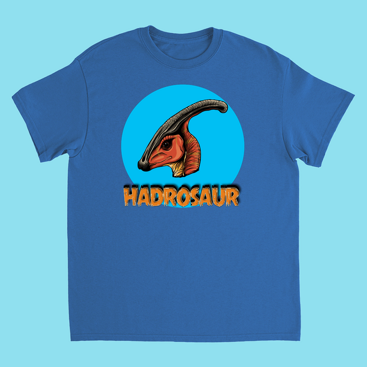 The Kids Hadrosaur Head T-Shirt by Jurassic Studio features an illustrated hadrosaur head in a blue circle with “HADROSAUR” below—perfect for young dinosaur fans or as a unique gift.