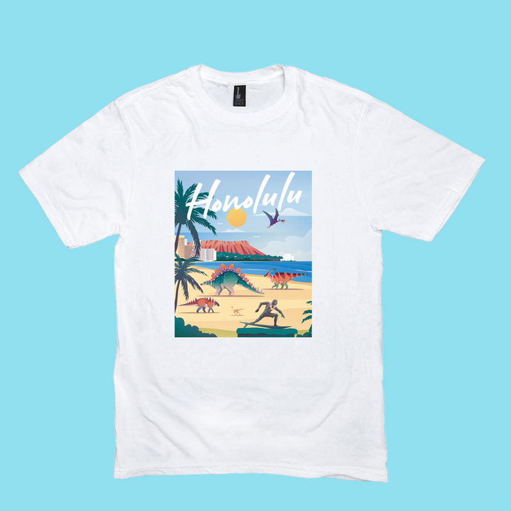 The Men Honolulu T-Shirt by Jurassic Studio is a white 100% cotton tee with a vibrant tropical beach scene, palm trees, people, and ocean, plus “Honolulu” in bold script on a light blue background.