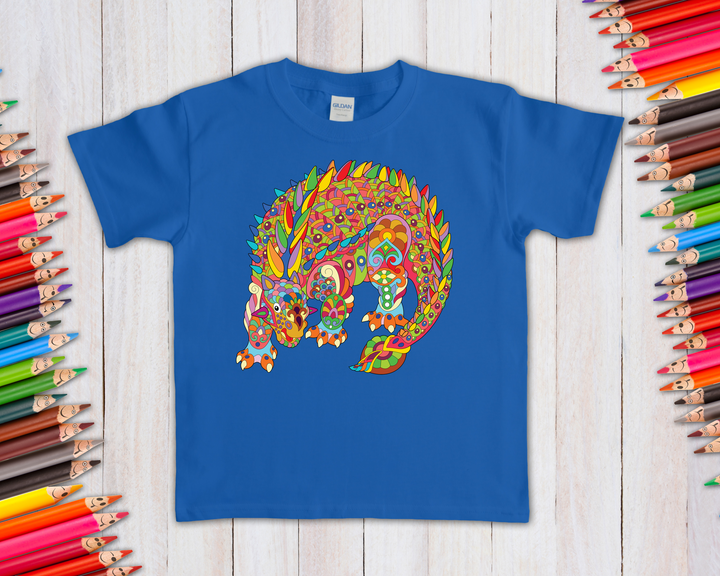 The Kids Ankylosaurus Zentangle T-Shirt by Jurassic Studio features a vibrant, patterned dinosaur graphic with colored pencils on a light wooden background—a unique gift for any dino fan and a Jurassic Studio exclusive.