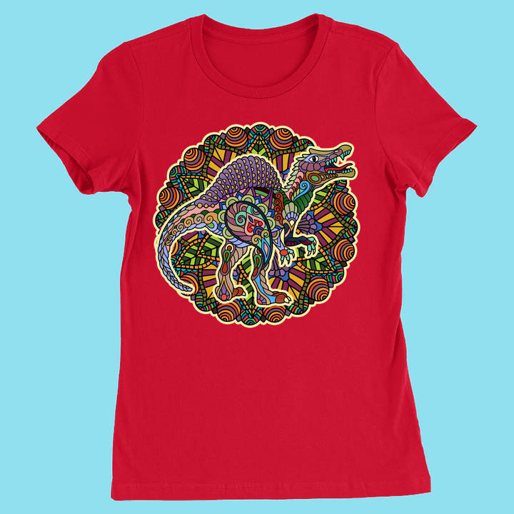 The Jurassic Studio Women Spinosaurus Mandala T-Shirt in red features a vibrant mandala-style dinosaur design on the front with a light blue background—perfect for dinosaur fans.