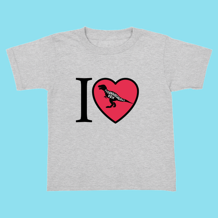 The Jurassic Studio Toddler I Love T-Rex T-Shirt is a gray tee with an “I ♥ dinosaurs” design, featuring a black T. rex silhouette in the heart—perfect for any young dinosaur fan!.